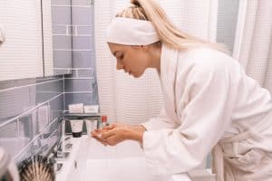 girl washing her hands at sink