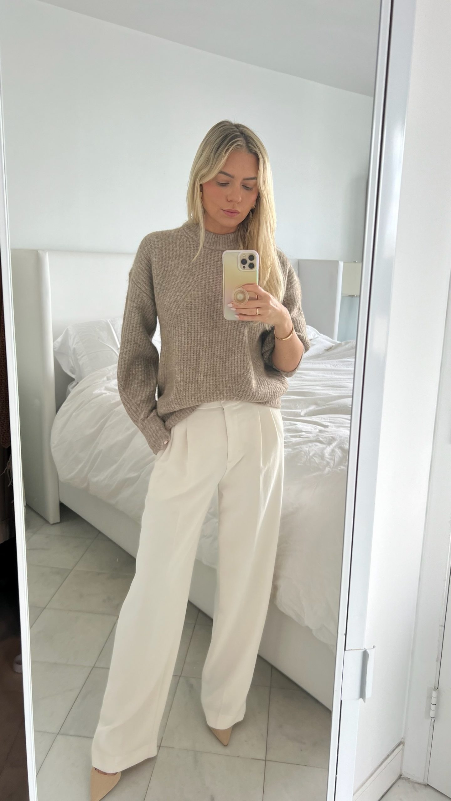 crewneck sweater with white trousers and heels