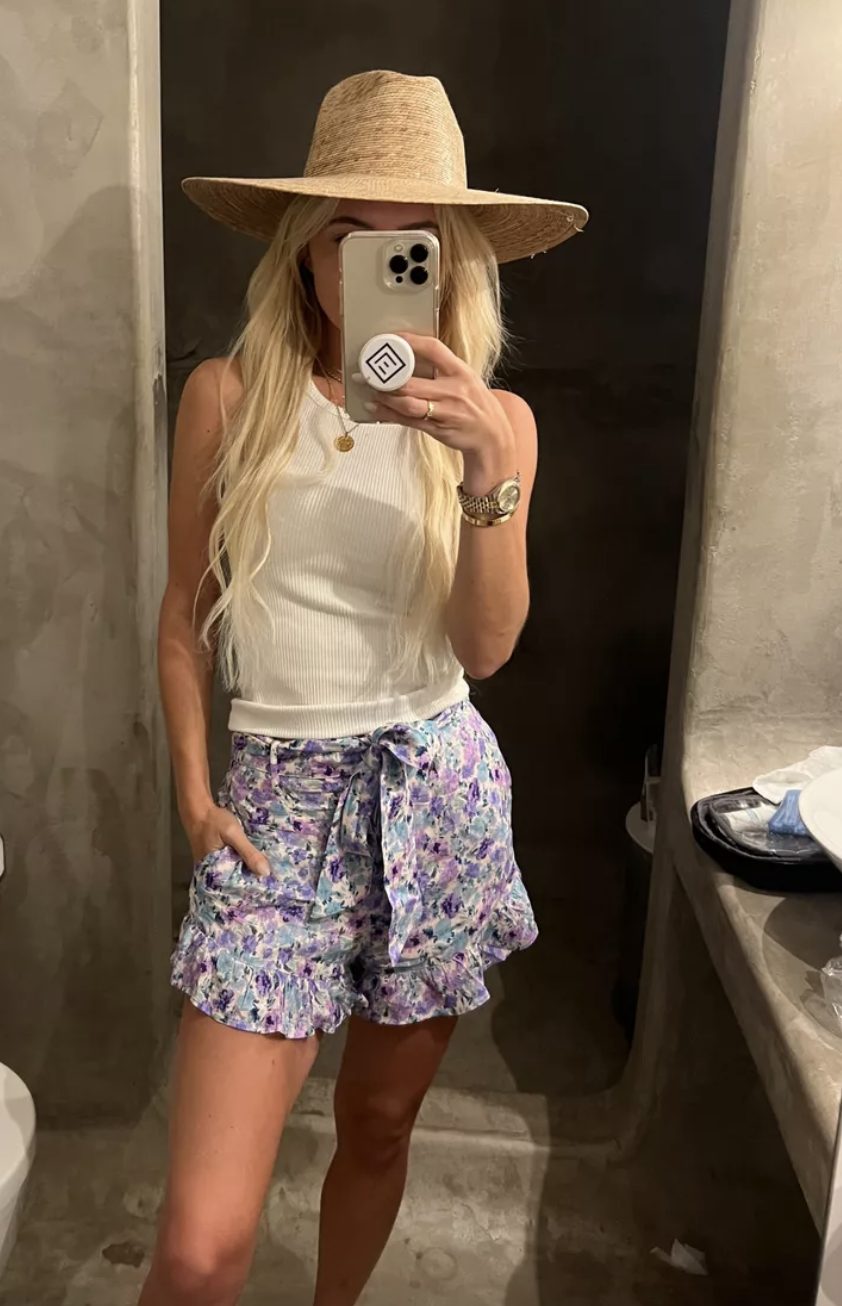Floral Shorts Outfit floral shorts with a white tank and a straw hat