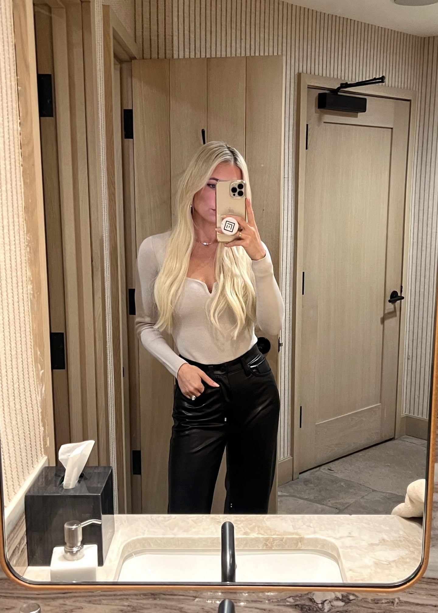 brown bodysuit with black leather pants